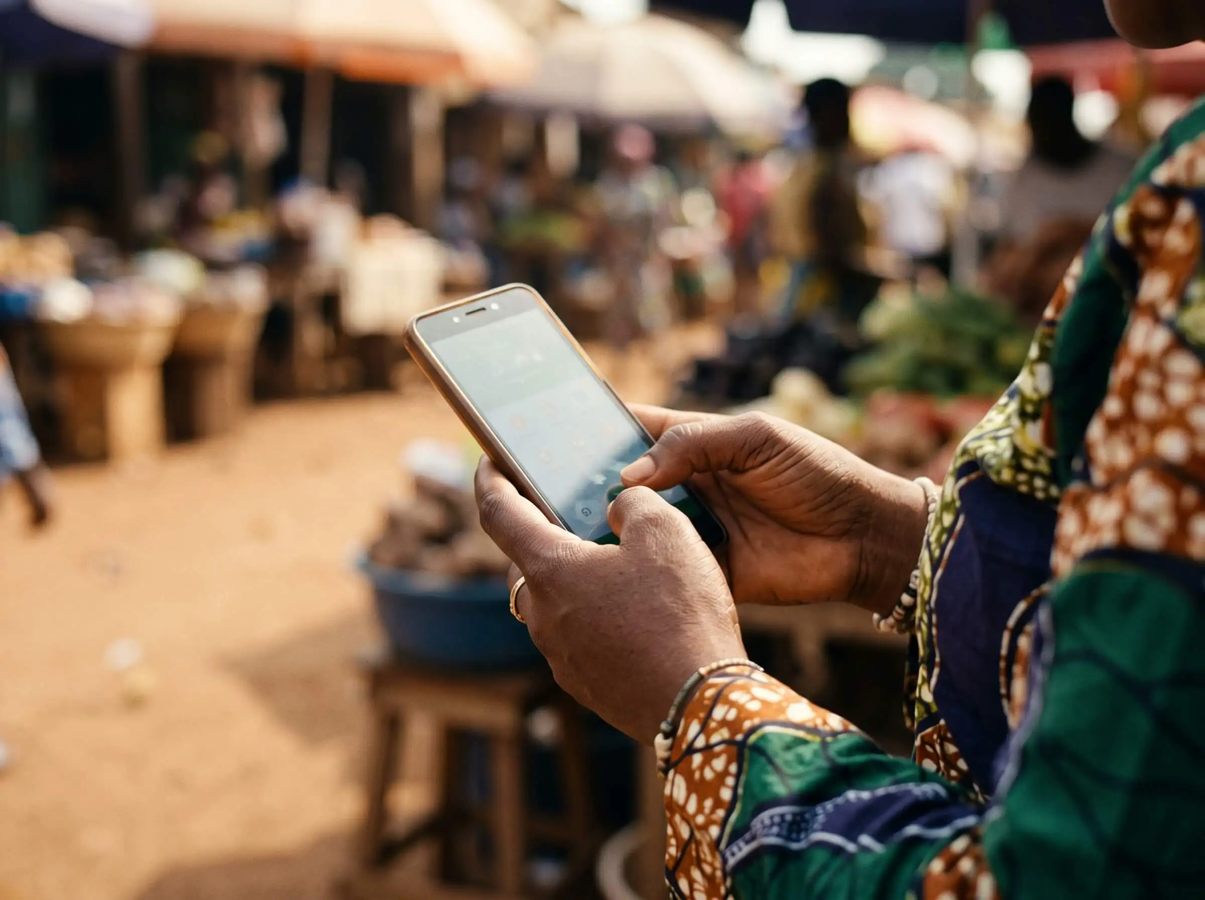 A member confirming a mobile money transfer on a phone